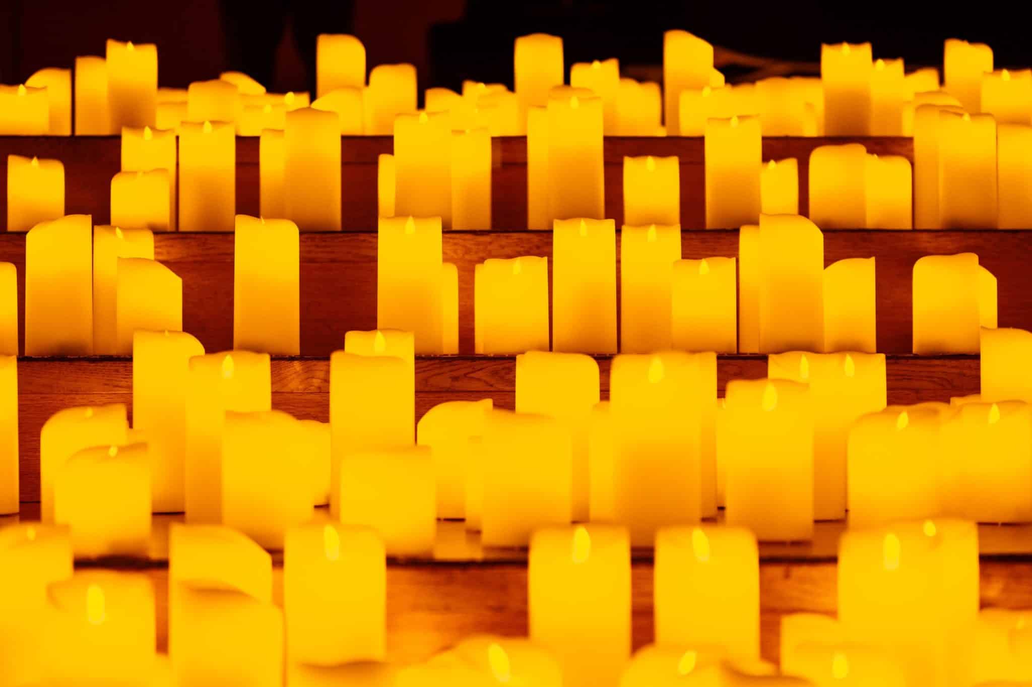 A close-up of candles displayed on multiple steps.
